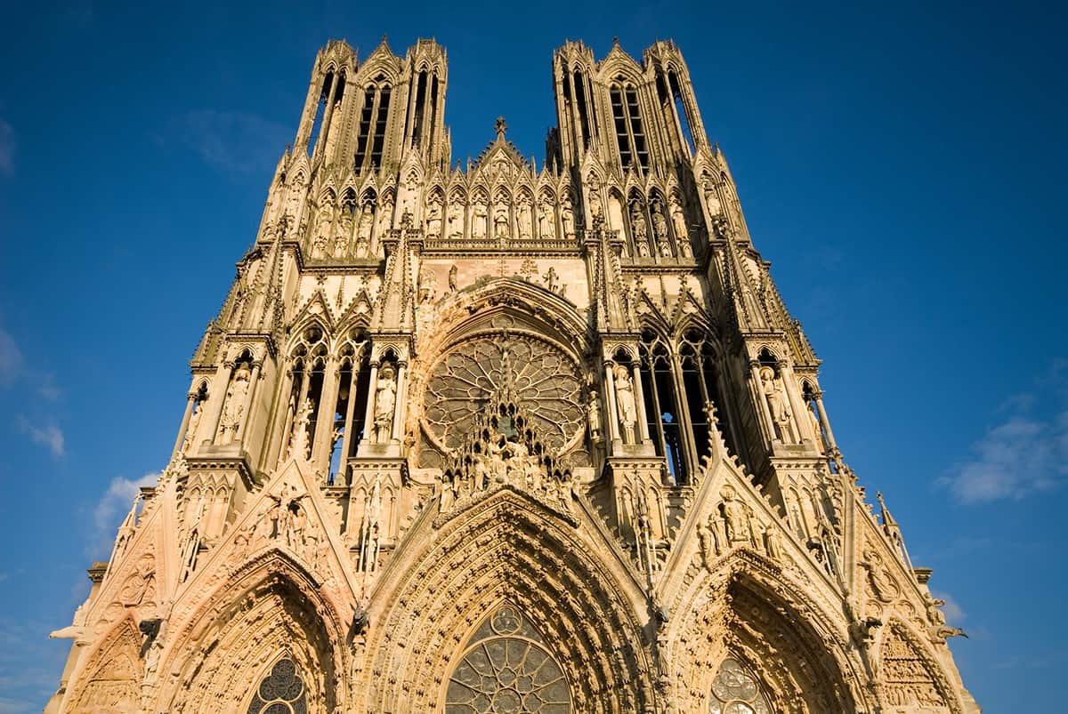 Reims Cathedral in Champagne France - Beautiful brownish building against blue sky