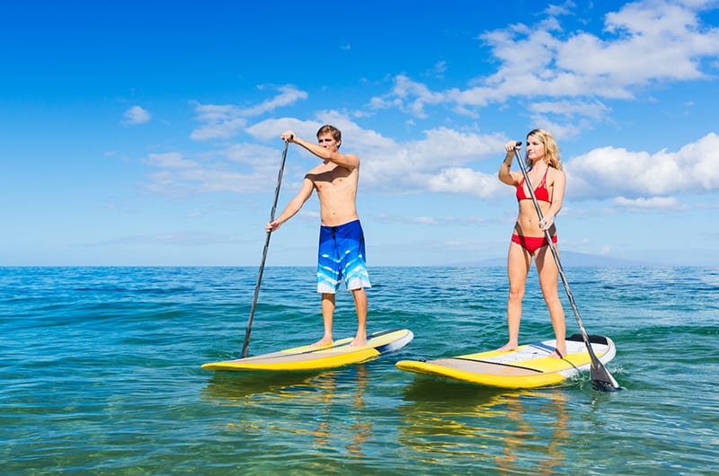 Couple Stand Up Paddling on the water