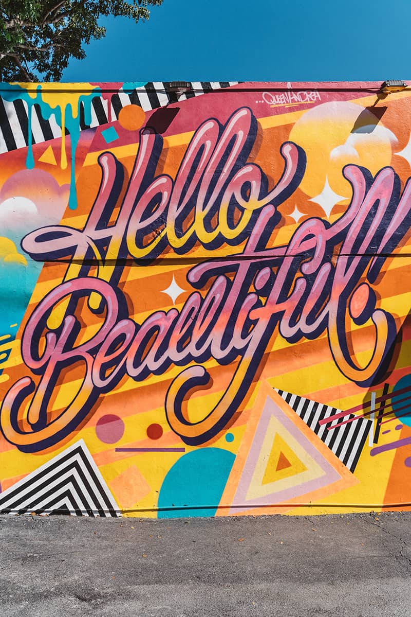 A colorful art wall in Wynwood Walls - a popular outdoor art museum great for a girl's weekend in Miami