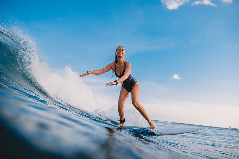 Girl surfing on blue water