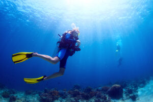 Underwater shot of a diver swimming in blue water - lots of underwater reefs and dive spots near Marco Island