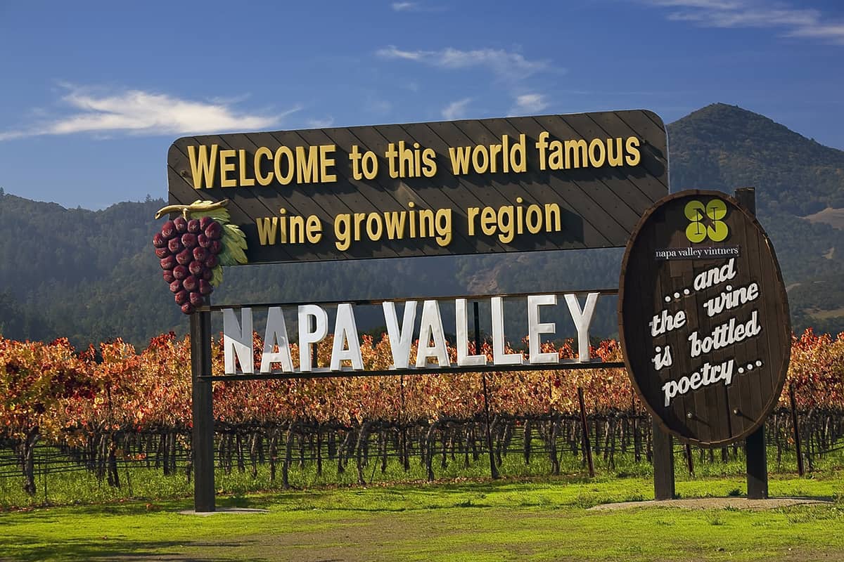 The famous welcome sign with vineyards in the background in Napa Valley, California