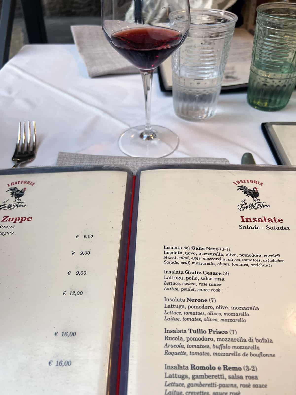 Food menu and glass of wine at a Roman restaurant
