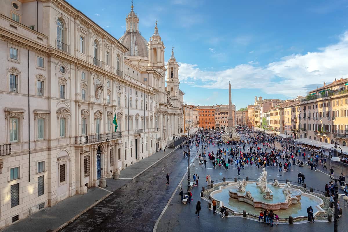 Busy Piazza Navona in Rome Italy - lots of people and architecture and the famous fountain