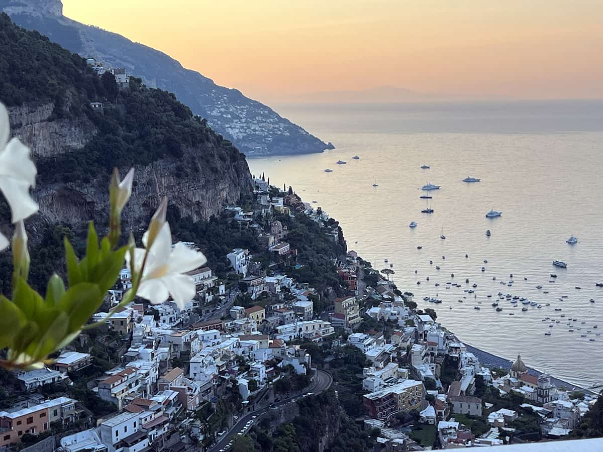Sunset overlooking the cliffside homes and water in Positano on the Amalfi Coast Italy